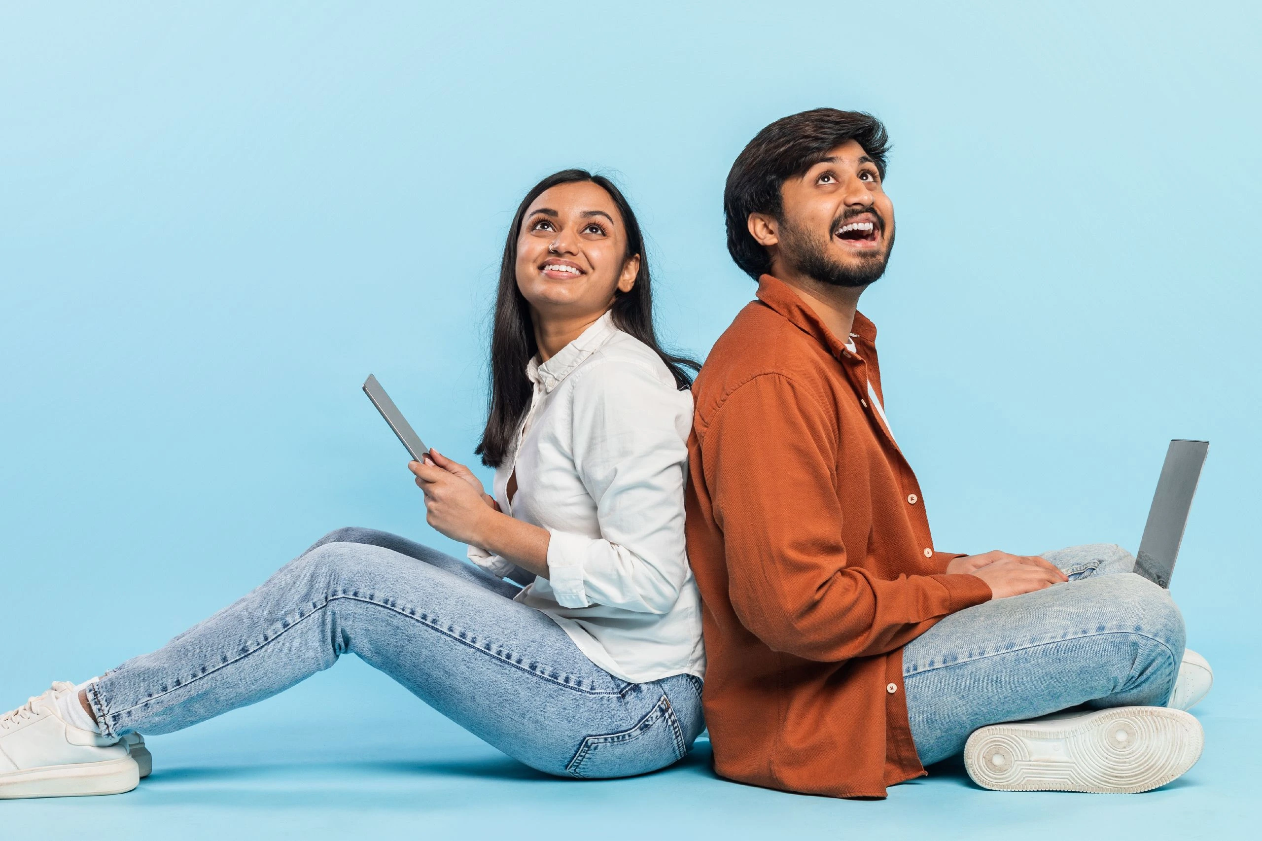 two people happy to get laptops on loan as device lock technology enabled lenders